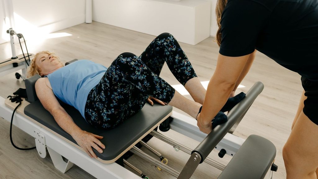 A physiotherapist taking a private 1-1 reformer session from our treatment room in Billericay Essex