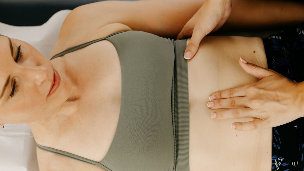 A women's health physiotherapist completing an assessment of diastasis rectus on a post natal patient